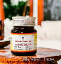 Mayana Thailam bottle with fresh herbs – traditional Siddha oil for joint pain, swelling, and stiffness.