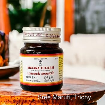 Mayana Thailam bottle with fresh herbs – traditional Siddha oil for joint pain, swelling, and stiffness.