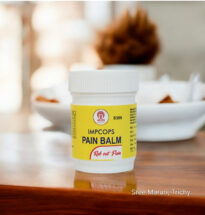 Pain Balm jar with herbal ingredients – used for headache, nasal congestion, and body pain relief.