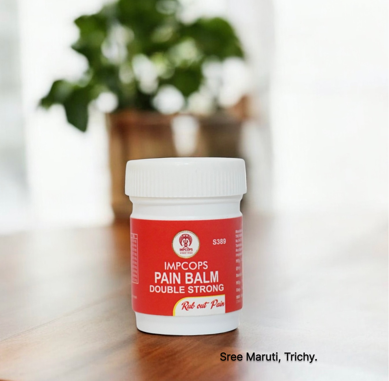Pain Balm Double Strong jar with herbal ingredients like menthol and eucalyptus – used for headache, nasal congestion, and muscular pain relief.