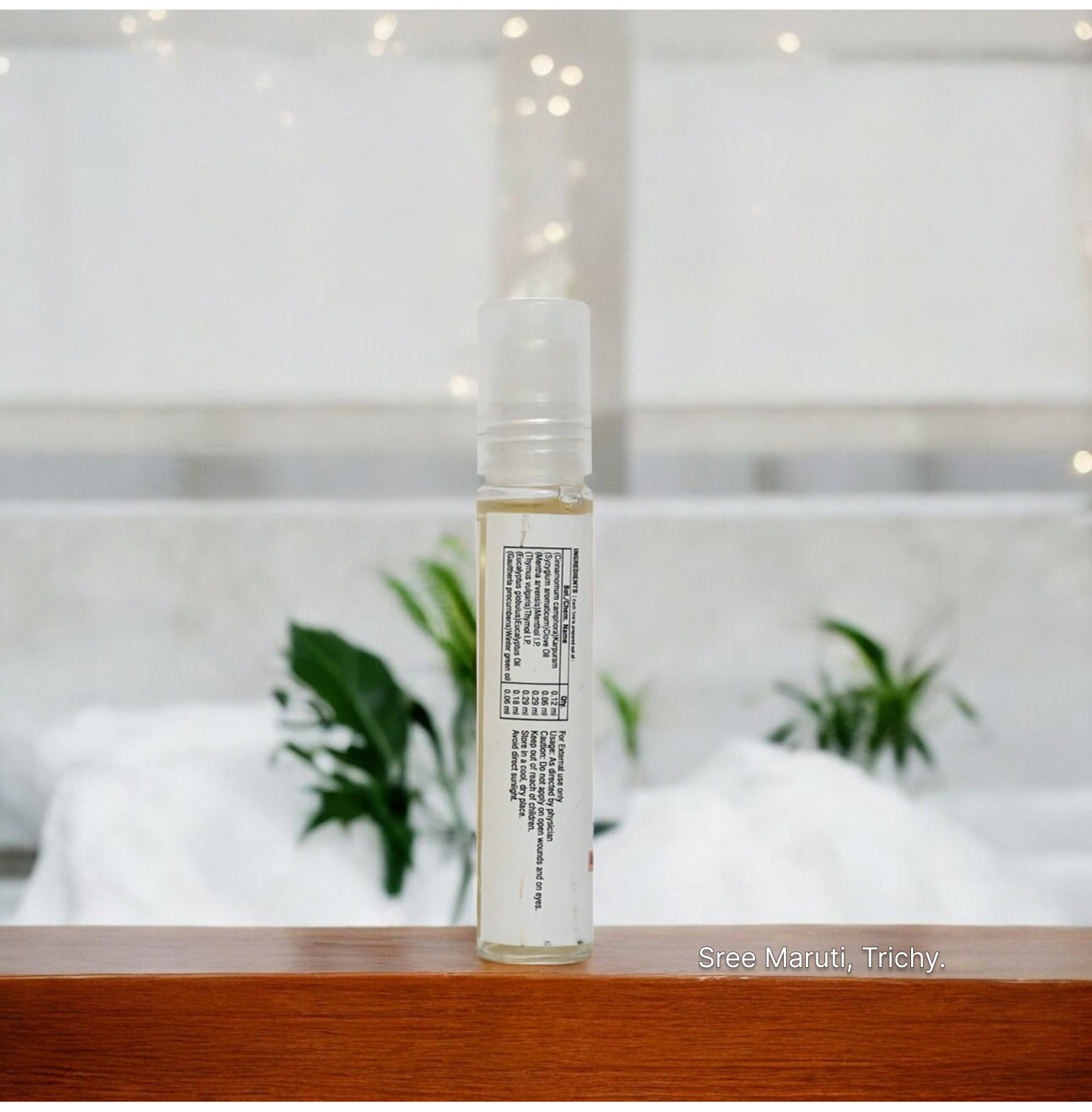 Pain Relief Roll-On bottle with herbal ingredients and a person applying it on the forehead – fast-acting remedy for headache, cold, and muscle pain.