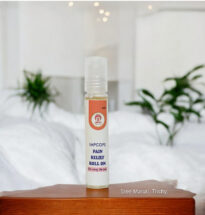 Pain Relief Roll-On bottle with herbal ingredients and a person applying it on the forehead – fast-acting remedy for headache, cold, and muscle pain.