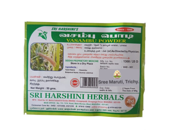 Vasambu powder and dried sweet flag root on white background