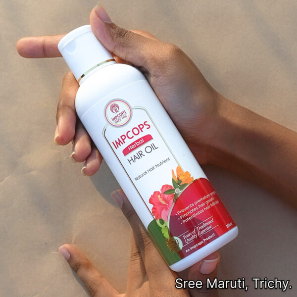 Herbal hair oil bottle with Ayurvedic herbs – natural hair care remedy.