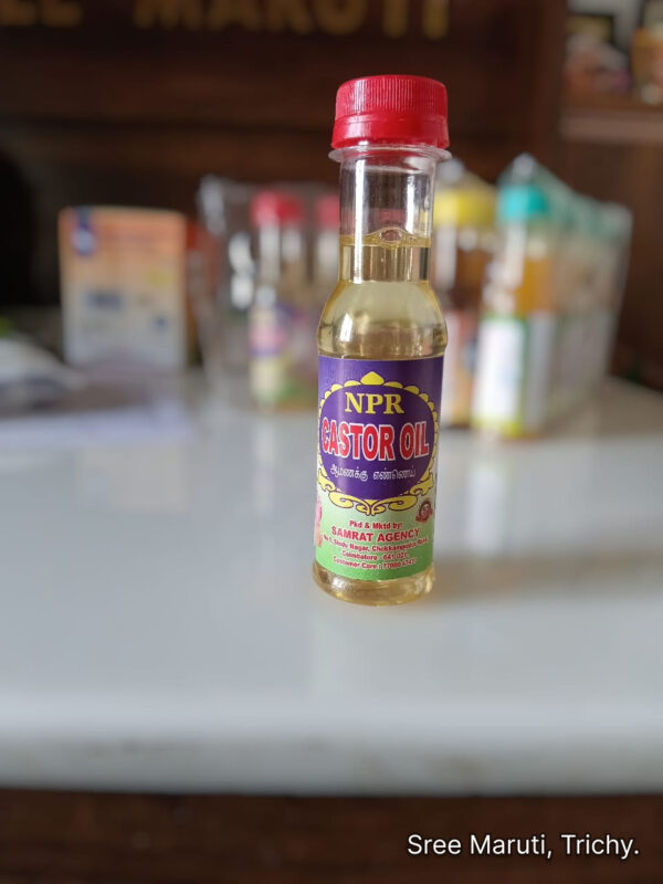 Pure NPR Castor Oil bottle with castor seeds and plant leaves