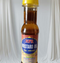 Pure mustard oil bottle with mustard seeds on a wooden surface.