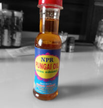 NPR Pungal Oil bottle with neem leaves and herbs for skin care