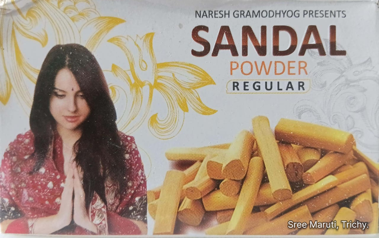 Natural sandalwood powder in a bowl with sandalwood sticks.