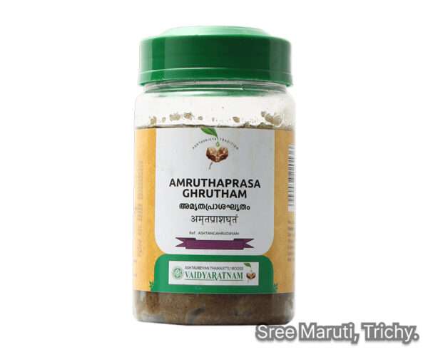 Ayurvedic medicated ghee Amruthaprasa Ghrutham in a brass bowl with herbal ingredients around it.