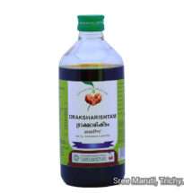 Draksharishtam bottle with grapes and Triphala – Ayurvedic fermented tonic for digestion and energy restoration.