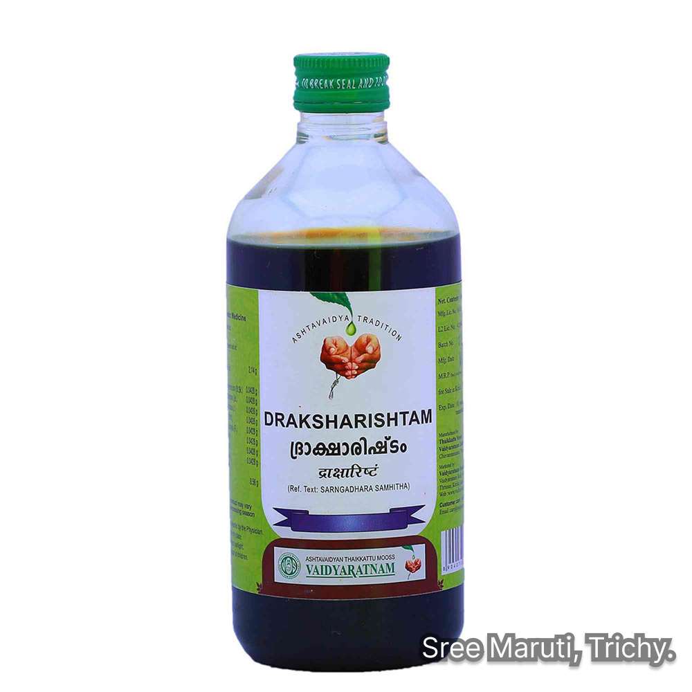 Draksharishtam bottle with grapes and Triphala – Ayurvedic fermented tonic for digestion and energy restoration.