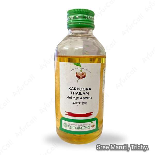 Karpoora Thailam bottle with camphor crystals and coconut oil.