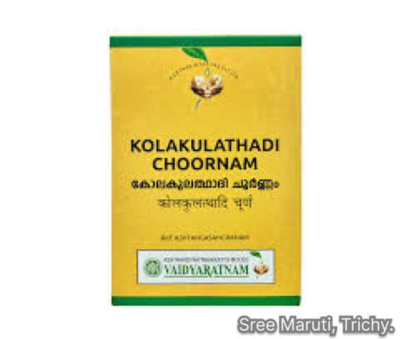 Bowl of Kolakulathadi Choornam Ayurvedic powder with herbs and spoon on wooden surface.