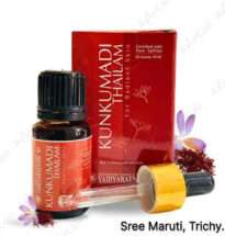 Bottle of Kunkumadi Thailam surrounded by saffron strands and sandalwood.