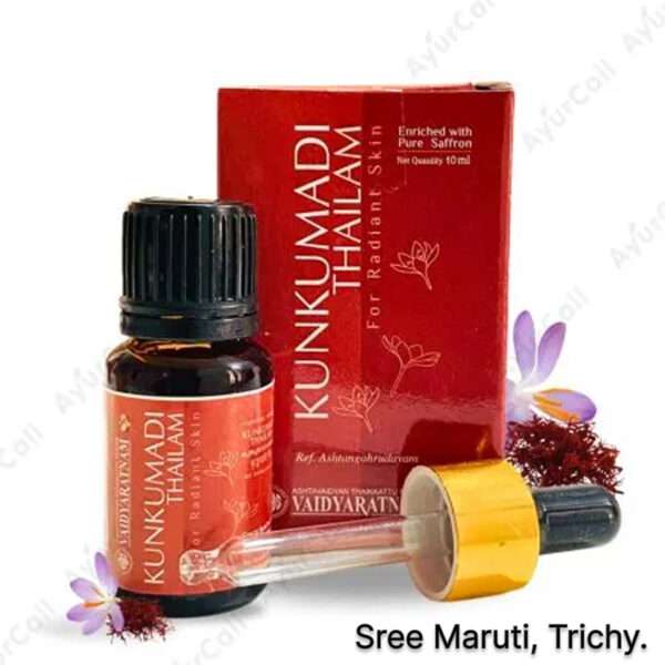Bottle of Kunkumadi Thailam surrounded by saffron strands and sandalwood.