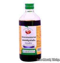 Bottle of Devadarvarishtam Ayurvedic tonic with cedarwood and herbs for skin and urinary health.
