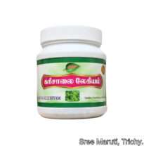 Karisalai Lehyam with bhringraj leaves in a glass jar.